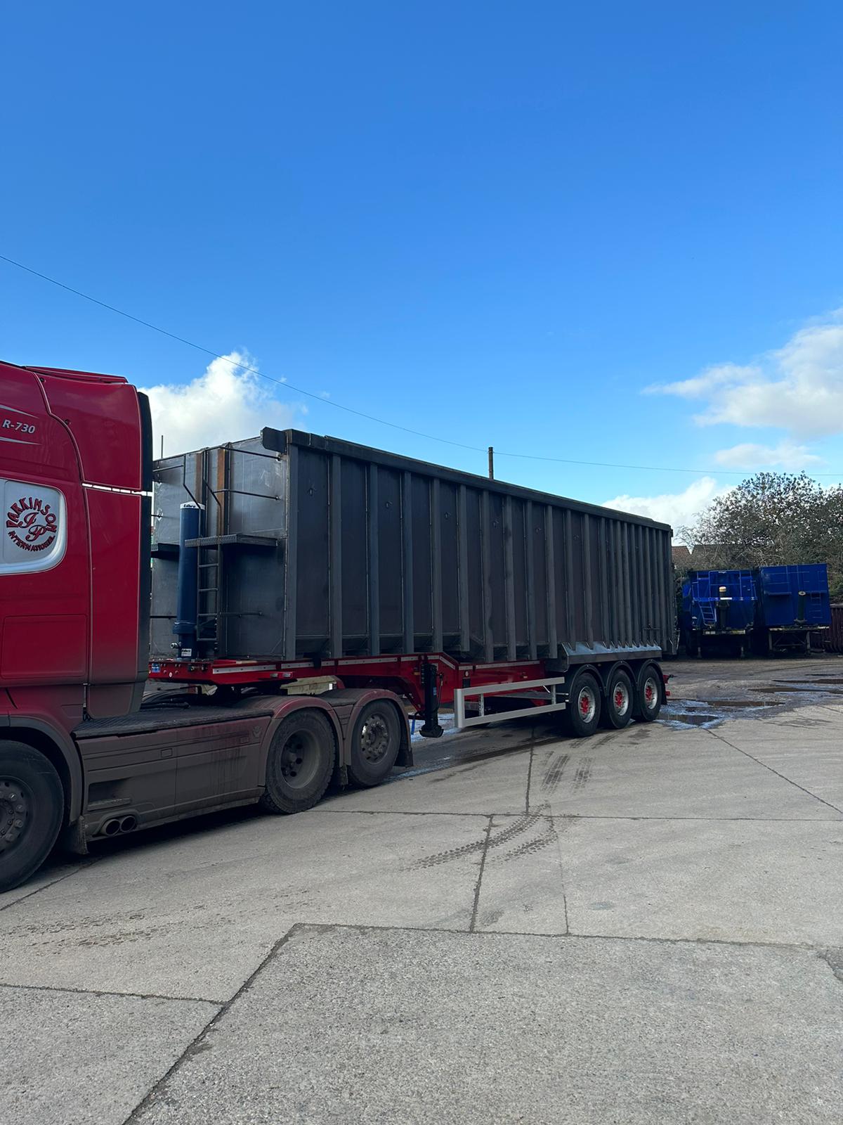 New steel tipping trailer coupled to a red Scania R730